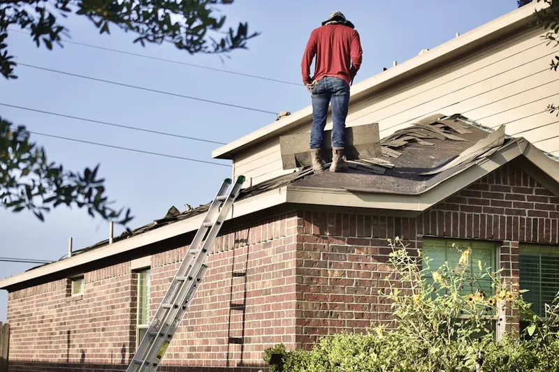 Professional roofer working on a residential roof in Oakview